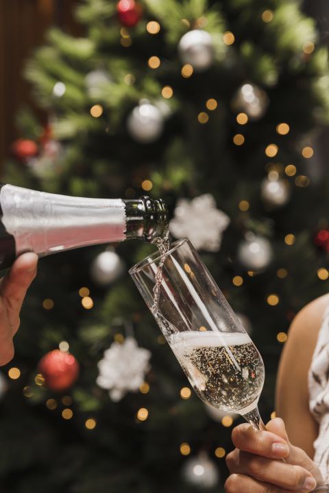 Hand die champagne inschenkt voor kerst